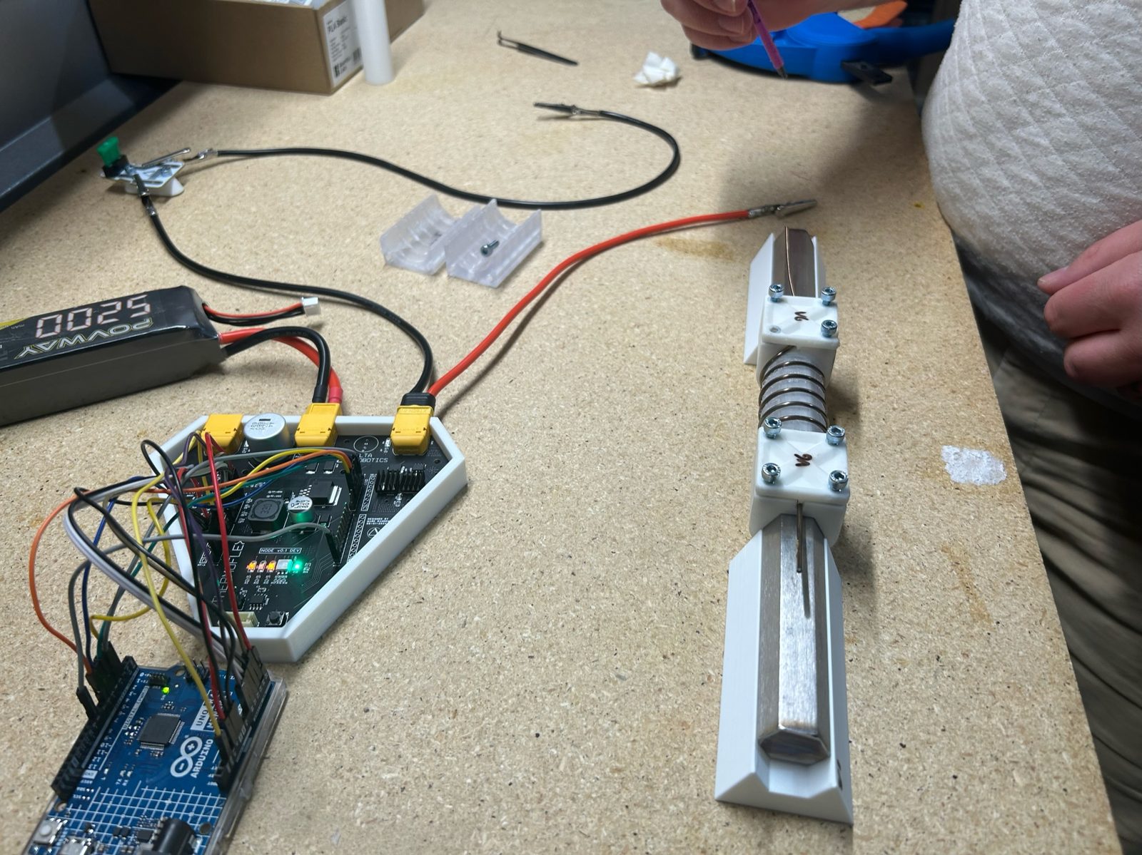 The first drive-electronics prototype under test against an SMA muscle. This is the board that failed.